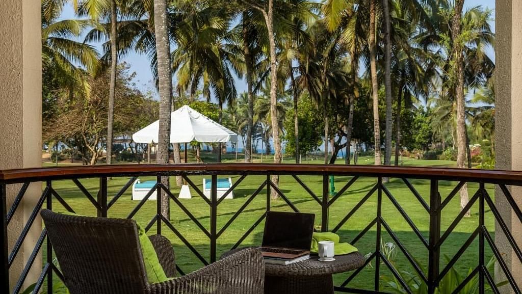 two chairs and a table in the balcony of a room - Caravela Beach Resort Goa