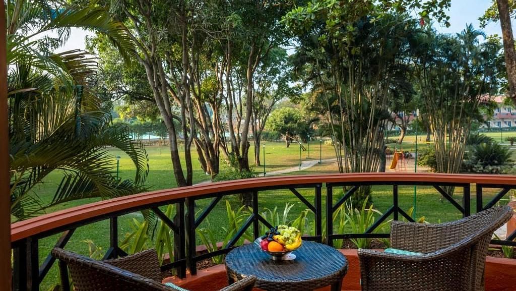 two chairs and a table in the balcony of a room - Caravela Beach Resort Goa