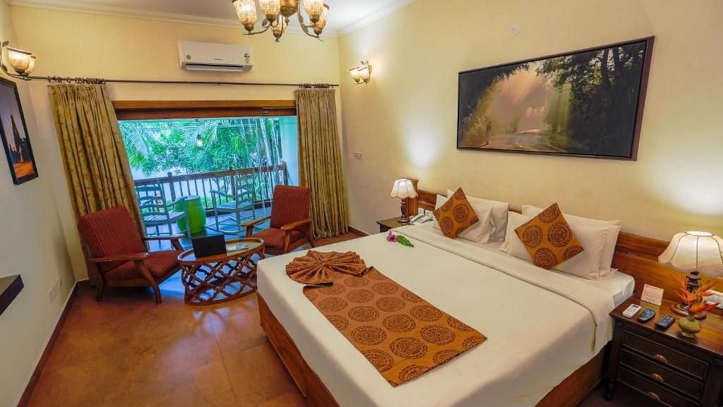  Spacious bed with decorative blankets, flanked by two bedside tables with lamps, and a large window to the side