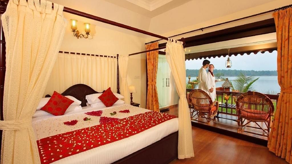 Bed warmly made with decorations and inviting lighting, set for a restful night with beazch view