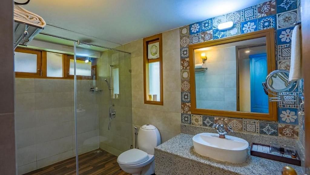 Bathroom with a mirror above the washbasin and separate lighting set for it