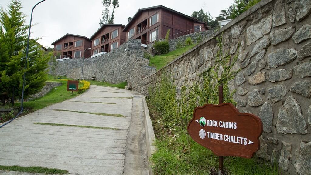 A facade image of the trail leading to the Rock Cabins surrounded by lush greenery - GReaT Trails Kodaikanal By GRT Hotels