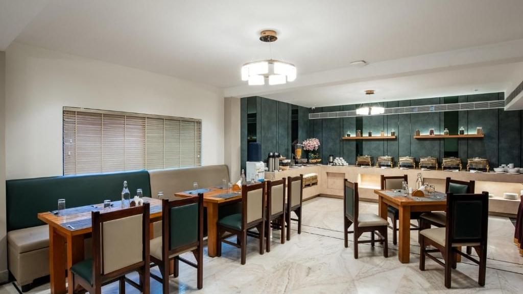 Modern dining space with wooden chairs and counters at Royal Group of Hotels