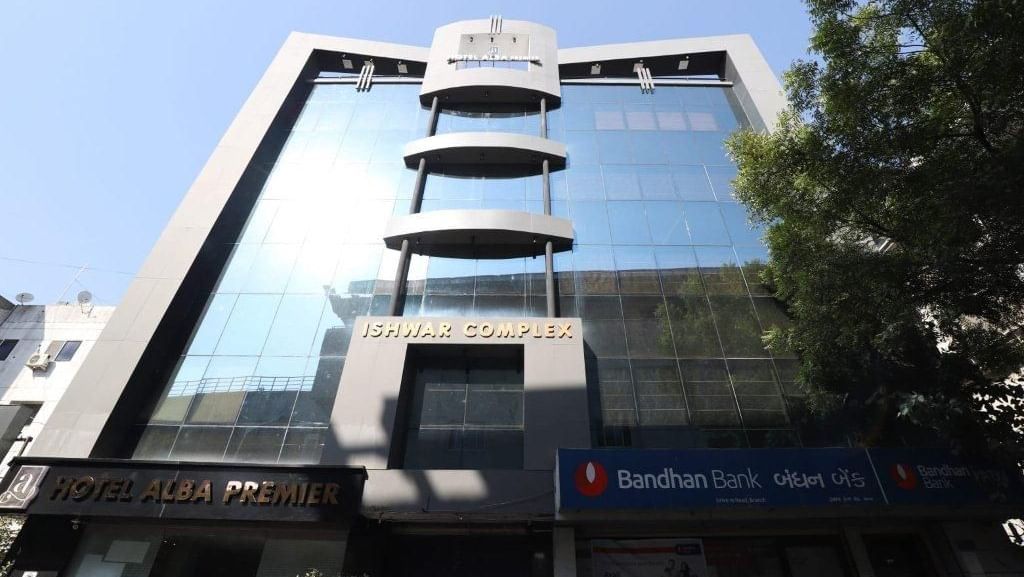 A bright facade of Pravasa Stay, Ahmedabad (Alba Premier), taken on a sunny day with a clear blu sky in the background.