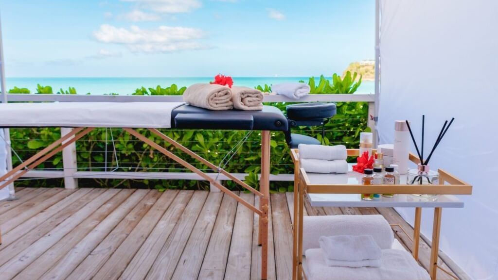 Serene spa setup with massage table and ocean view at Tamarind Hills Resort and Villas – Antigua.