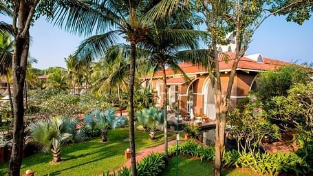 an overview of Caravela Beach Resort Goa with a garden and rooms in view