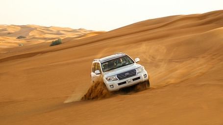 An image of a car being driven in the desert
