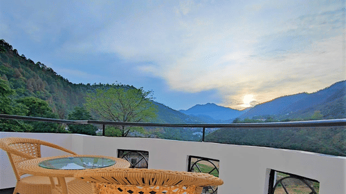 Balcony view of the mountains amidst which the sun is rising