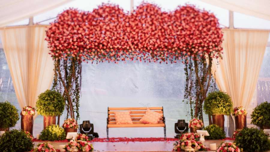 An event space Aura at Avana Resorts, featuring decorated chair set up on a stage.