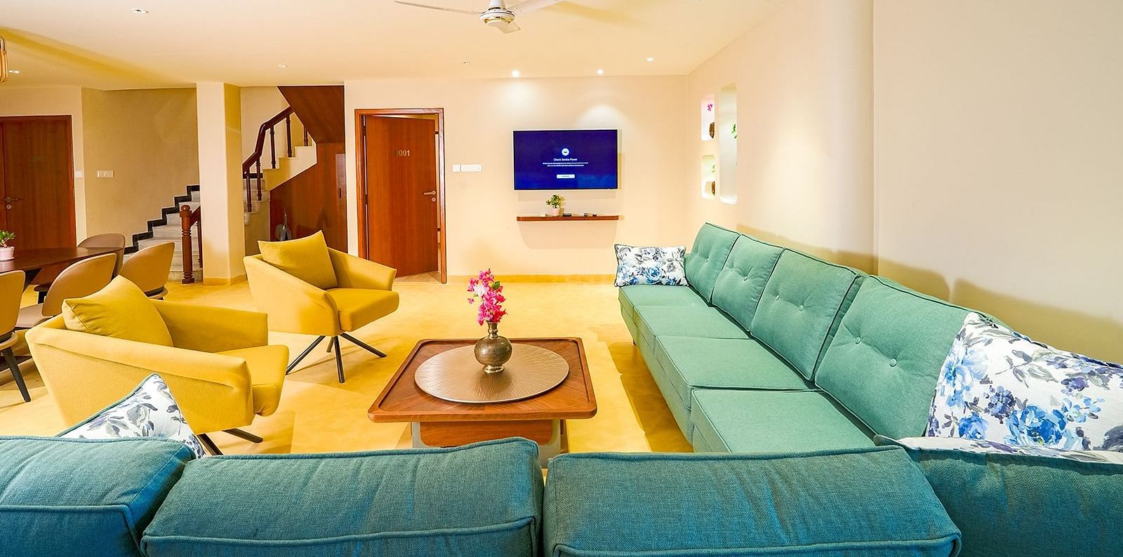 Vasundhara Villa vibrant living room with plush seating, flat-screen TV, and modern interiors at Ramoji Film City.