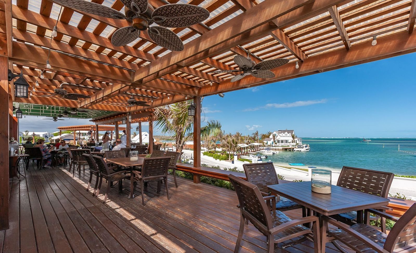 Covered outdoor restaurant seating with ocean in the background | Abaco Inn