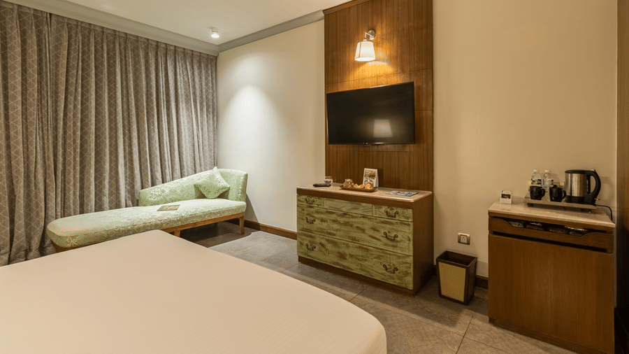 club rooms in south goa designed with a cosy bed and elegant interiors