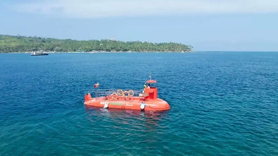 An orange bodied Semi Submarine in blue green clear waters
