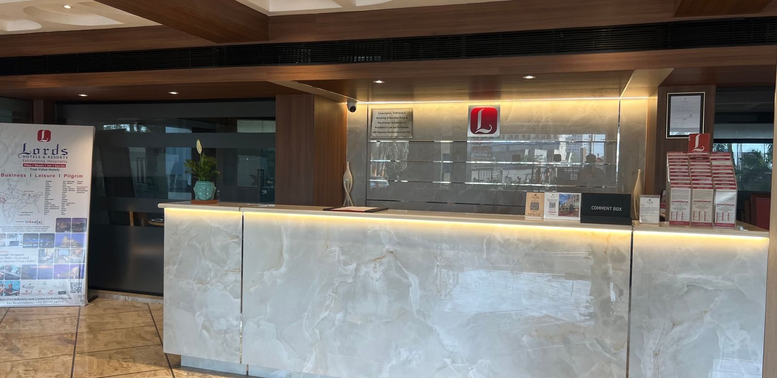 Reception area at Lords Eco Inn Dahej with a sleek front desk and warm lighting.