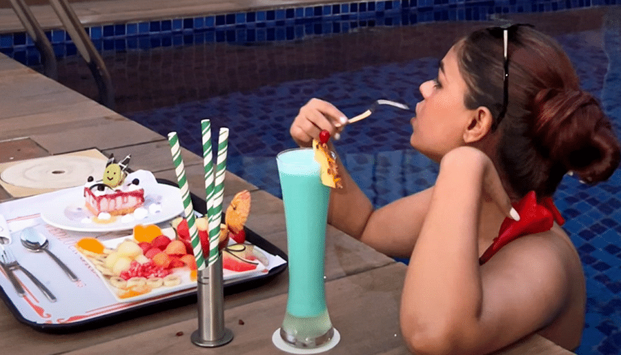 alt-text Woman relaxing by the poolside, enjoying a colorful drink