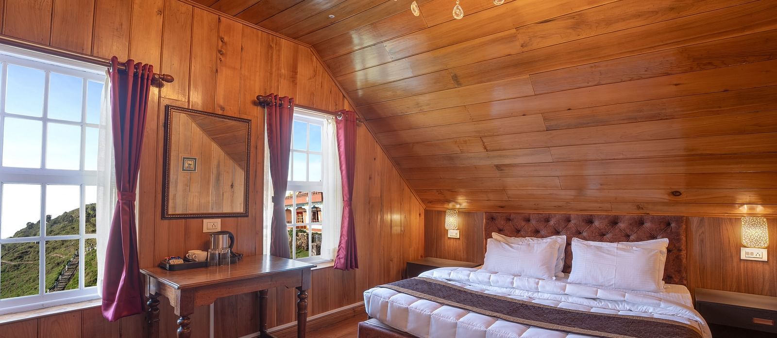A room at Poshtel, Meghma with a double bed and side tables