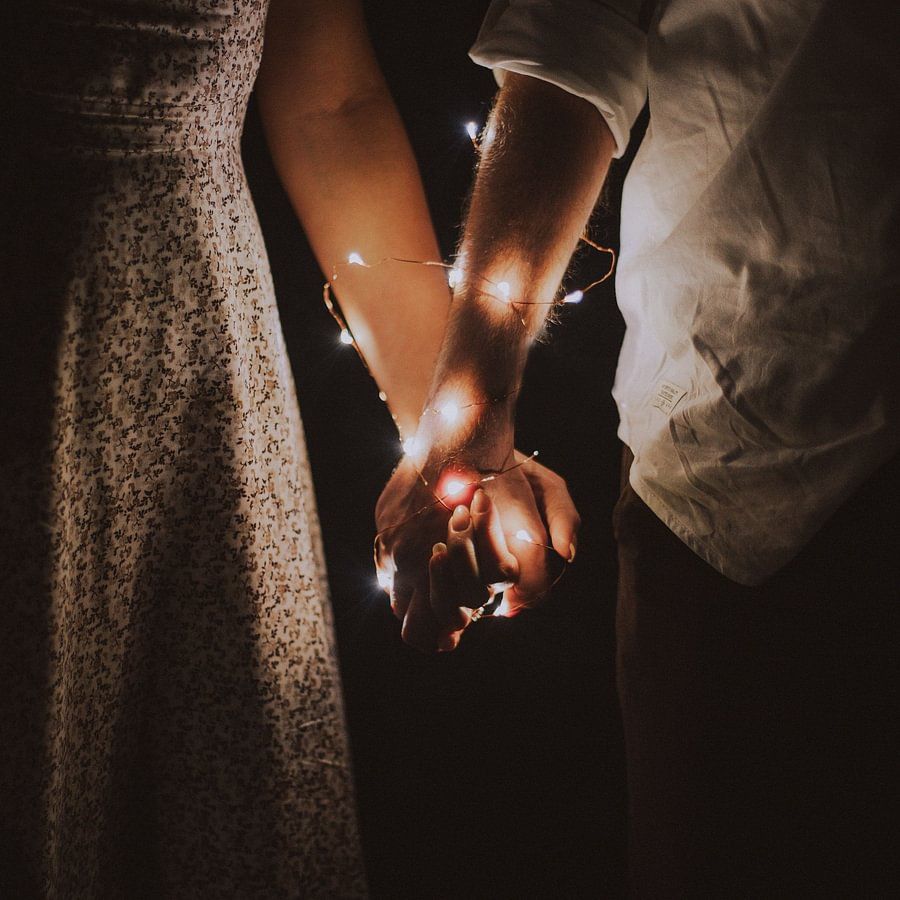 Couple's hands wrapped in fairytale