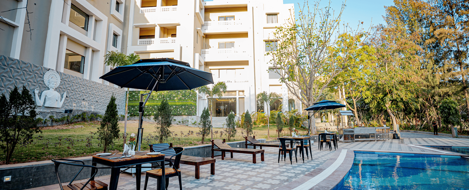 Image of a pool with seating area on the side at Essentia Luxury Resort and Spa, Udaipur