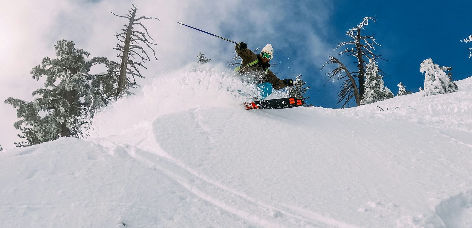 A person snowboarding down a snowy mountain slope.