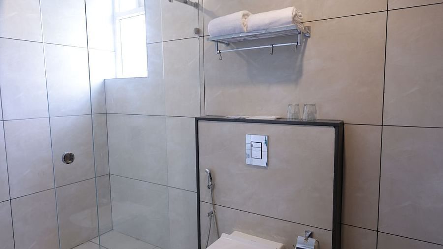 A bathroom with a separate shower area  and towels