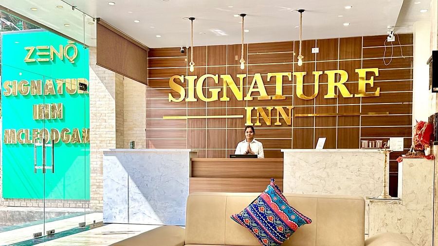 image of the reception with an off-white leather sofa in front of it - ZENQ SIGNATURE INN, MCLEODGANJ