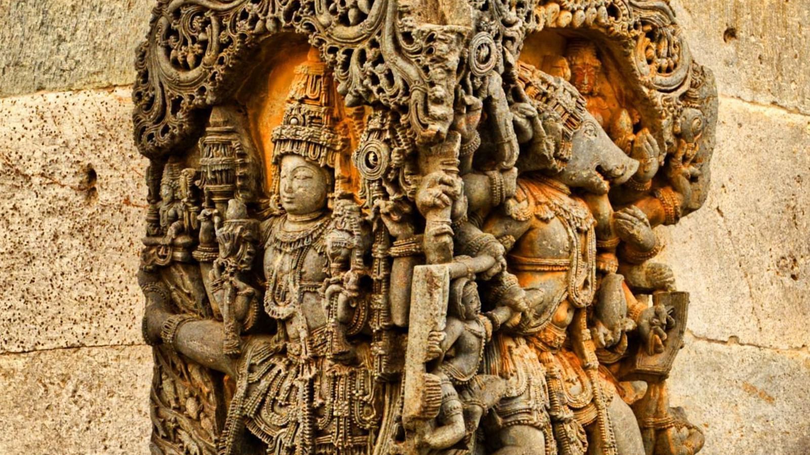 A close up of a intricate carvings on a rock on the side of the outer wall at Doddagaddavalli Temple.