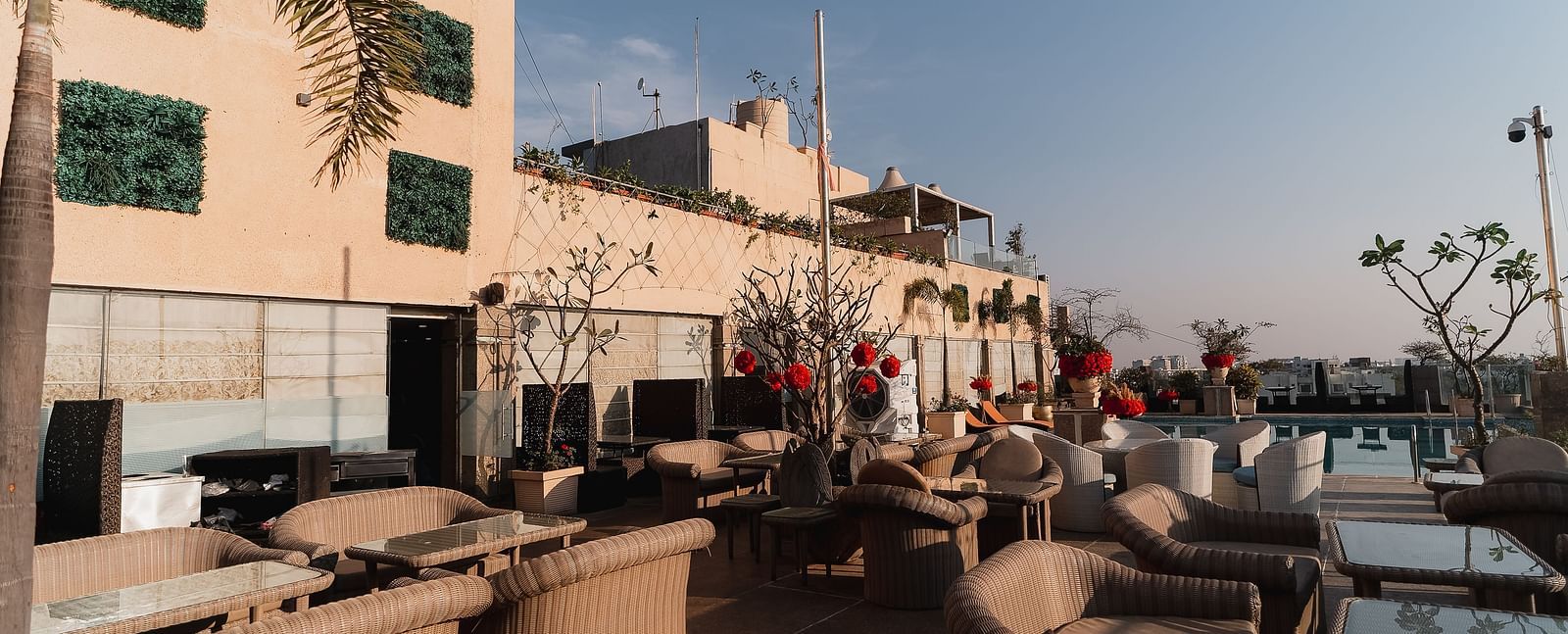 An outdoor seating area, possibly at a restaurant with tables and chairs at Hotel Ashok Nagpur.