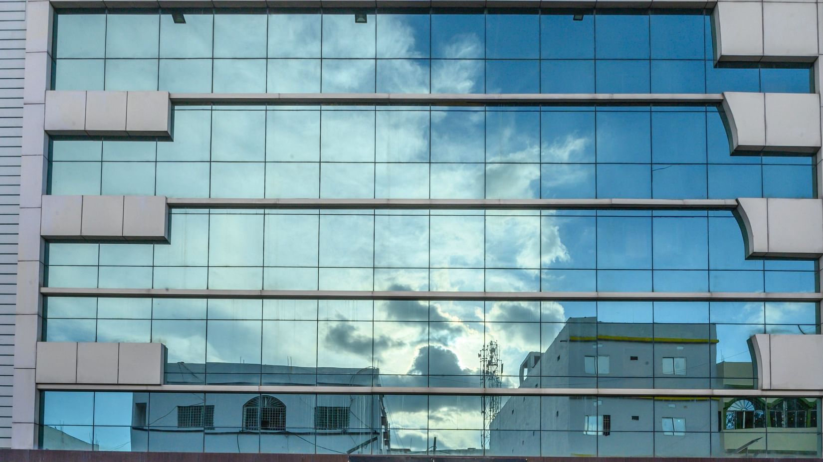 Hotel facade featuring a glass-covered building at Biznotel by Pride, Deoghar.