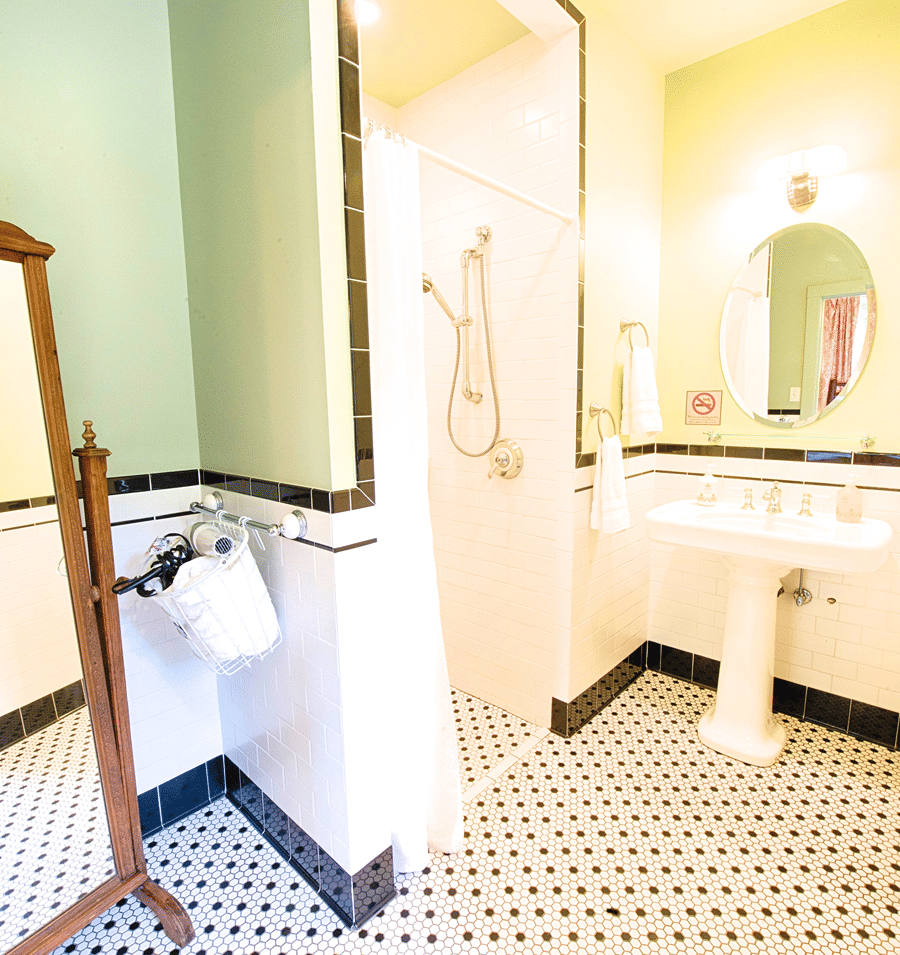 A clean and well-appointed bathroom with a shower, sink, and mirror.