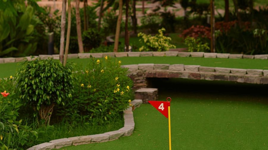 A view of the pole with a flag in the golf course - Ananta Udaipur