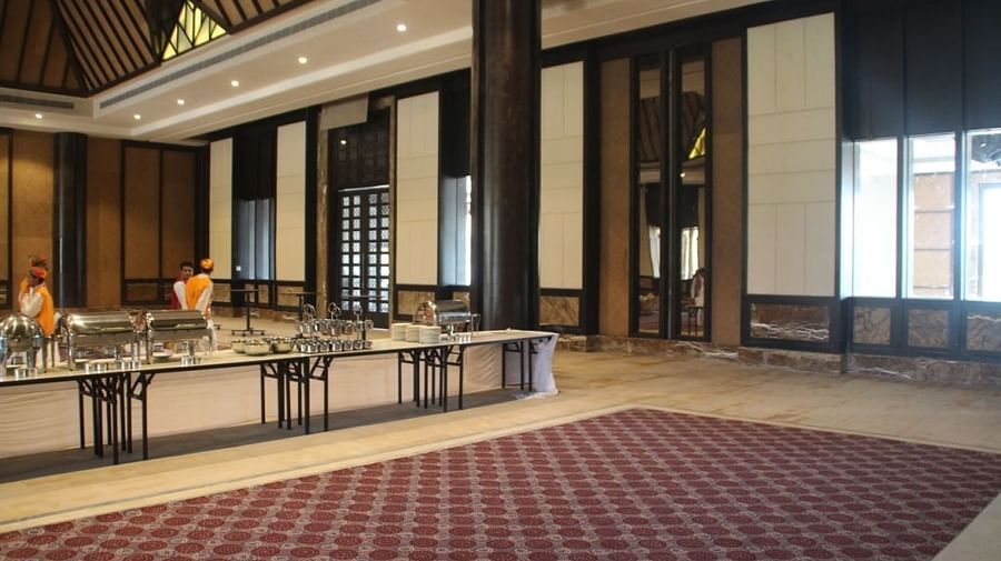 Tables with a carpet in the centre inside a banquet hall for an event - Ananta udaipur