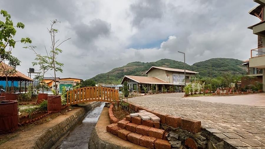 resort view from afar with small bridge - Mastiff Grand La Villae Resort, Lonavala