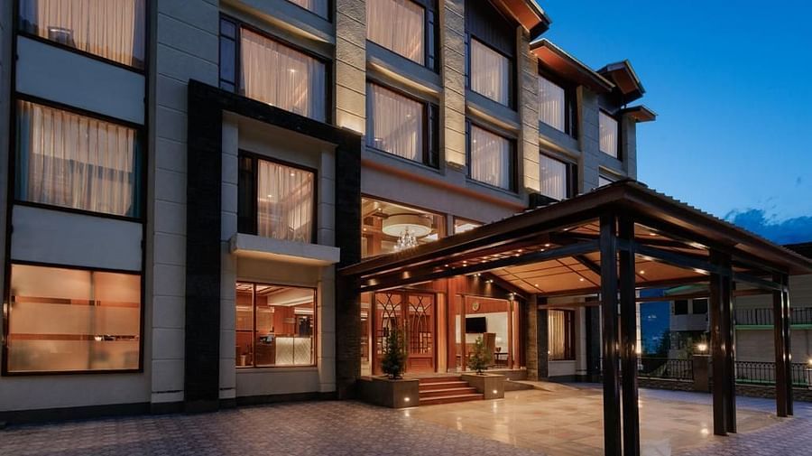 Entrance of The Orchid Hotel Manali with large windows