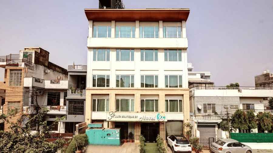 A full vertical shot of the multi-storey hotel building during the day, showcasing its modern architecture and prominent signage against a clear sky - Flute Boutique By Hotel 91, Jaipur