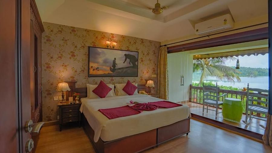 Large bed with two bedside tables and lamps, featuring a photo frame above it