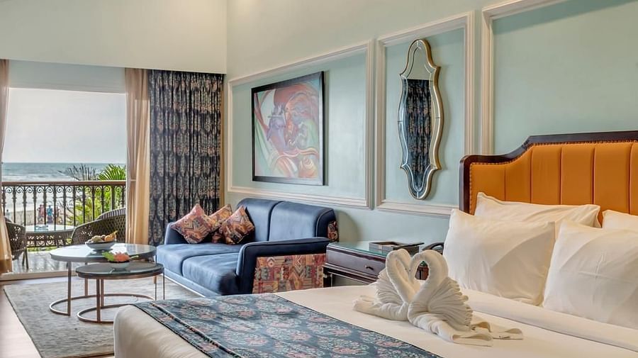 a king size bed and a seating space beside it - Mayfair On Sea, Morjim, Goa