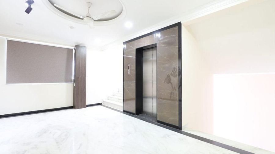 Corner-view shot of the elevator at the end of the reception area at Pravasa Stay, Ahmedabad (Alba Premier).