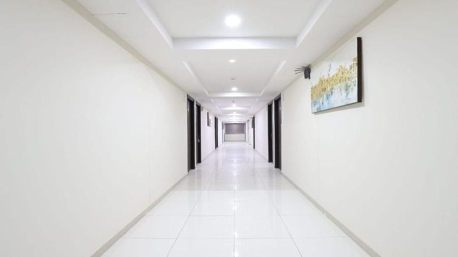Full view of an empty and neatly-leptcorridor at Pravasa Stay, Ahmedabad (Alba Premier).
