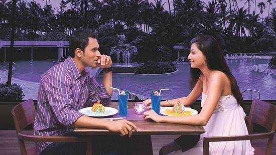 a couple enjoying a poolside meal 