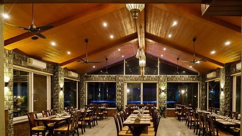 restaurant with tables and chairs - Mastiff Grand La Villae Resort, Lonavala
