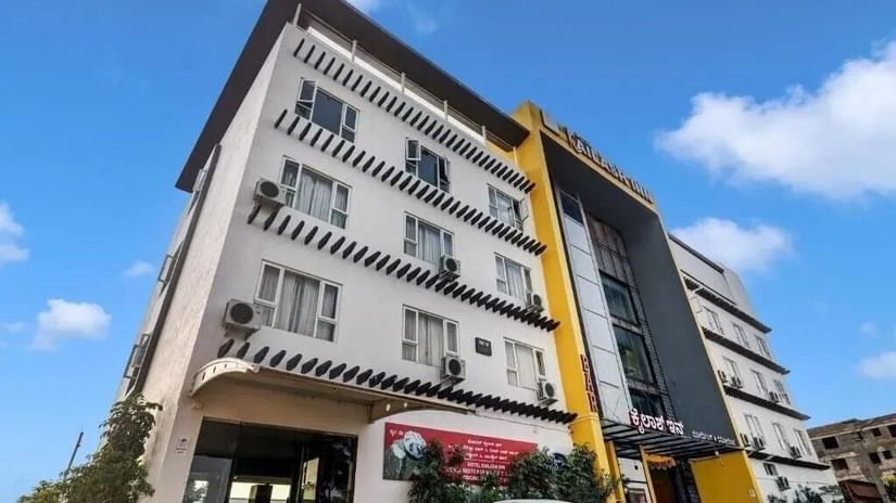 The exterior of a modern multi-story hotel building with yellow and grey accents under a blue sky - VITS Select Kailash Inn, Bagalkot