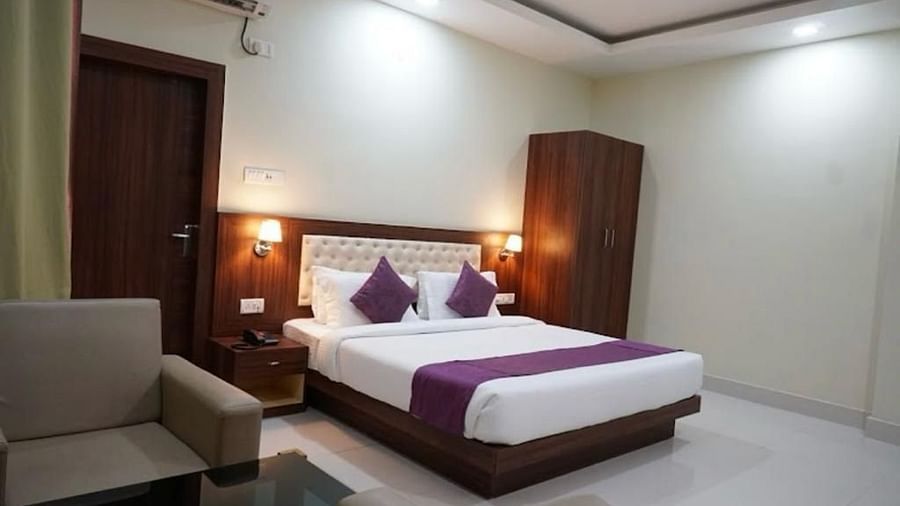 A neat and modern room with minimalist décor, soft lighting, and a warm, welcoming vibe - Pemaling Lords Eco Inn Guwahati