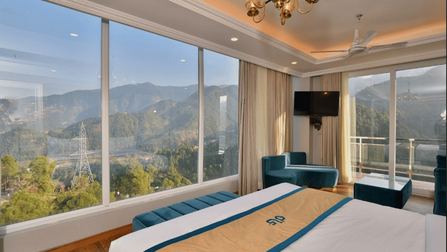 Claret Inn, Dalhousie - Room with a bed and panoramic windows showing outdoor mountain views.