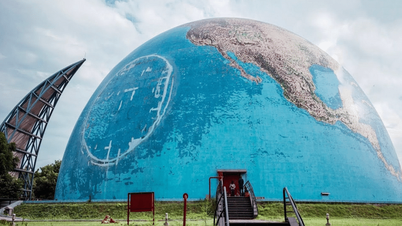 An exterior view of Science City in Ahmedabad, featuring the striking structure of a half globe that showcases innovation and creativity.