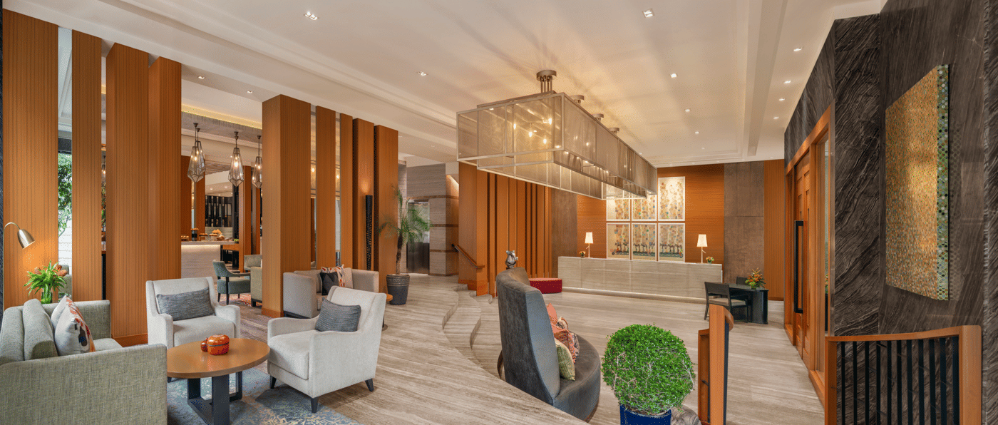 Living area with sofas, chairs, and wooden interiors at The Raintree, St. Mary’s Road.