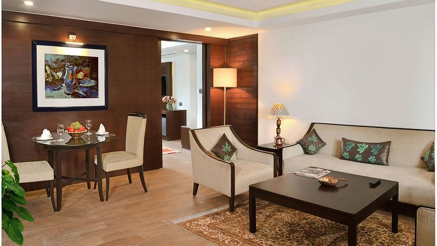 Executive Suite at Golden Tulip, Srinagar featuring sofa sets and table seating arranged in the living room