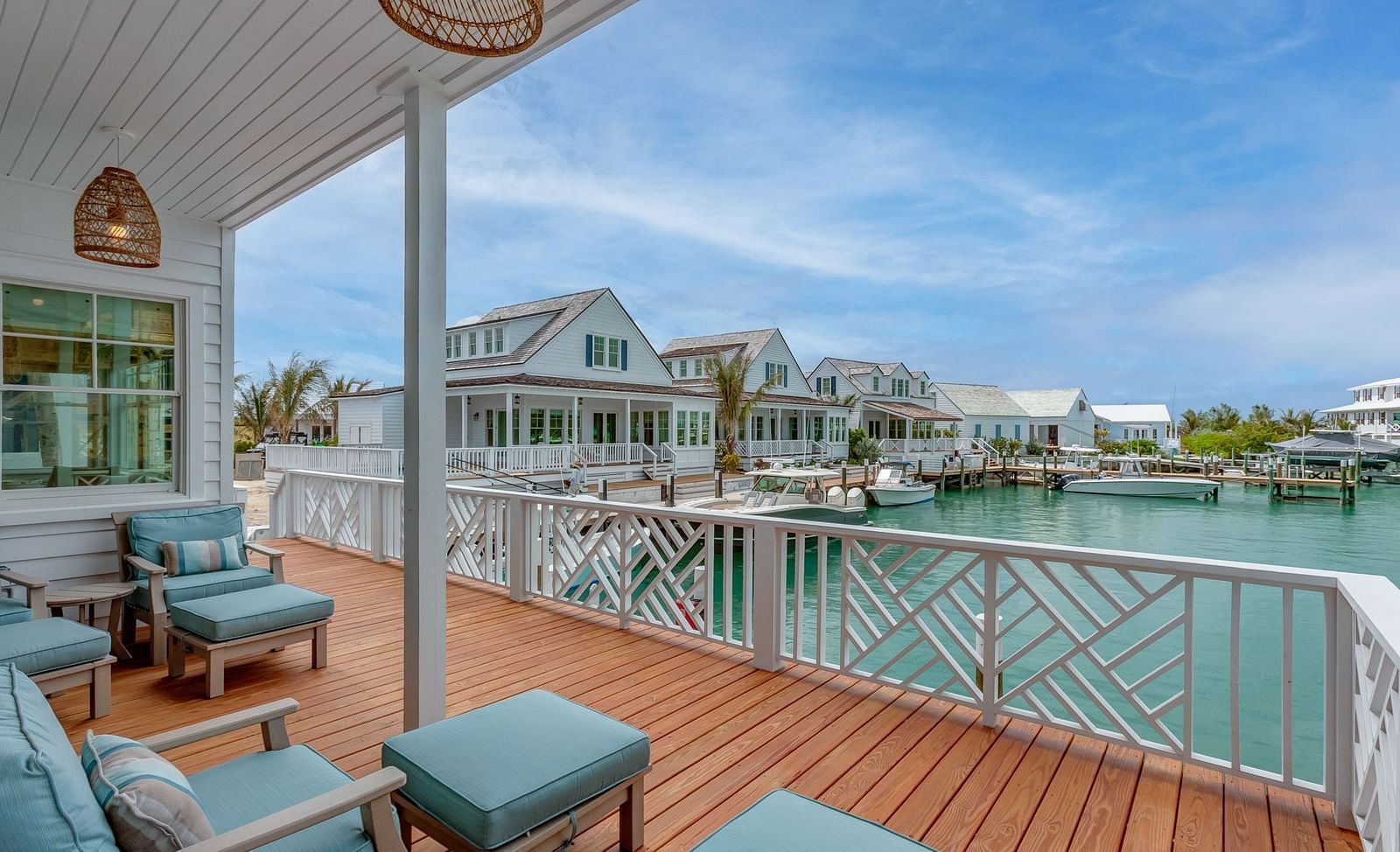 Waterfront deck with cushioned seating and a covered patio area | Abaco Inn