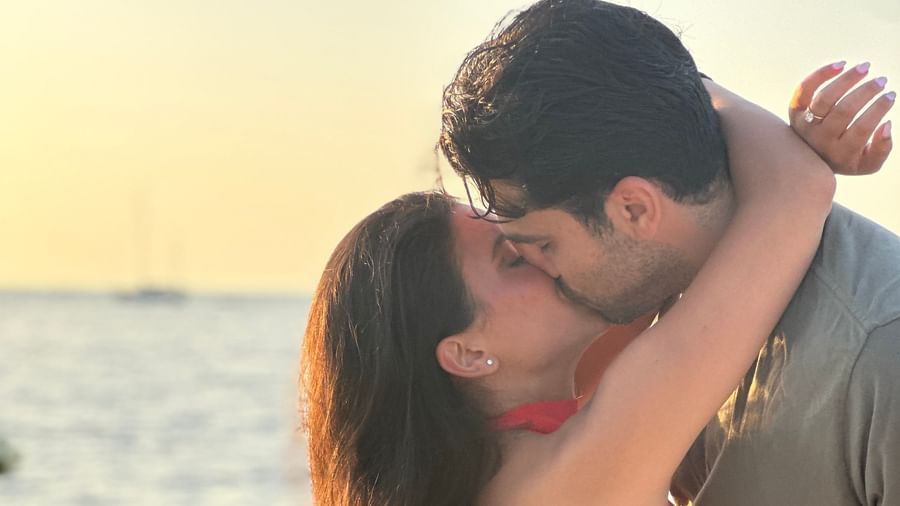 A close-up of a couple kissing with a beautiful sunset in the background at Casa Morada.