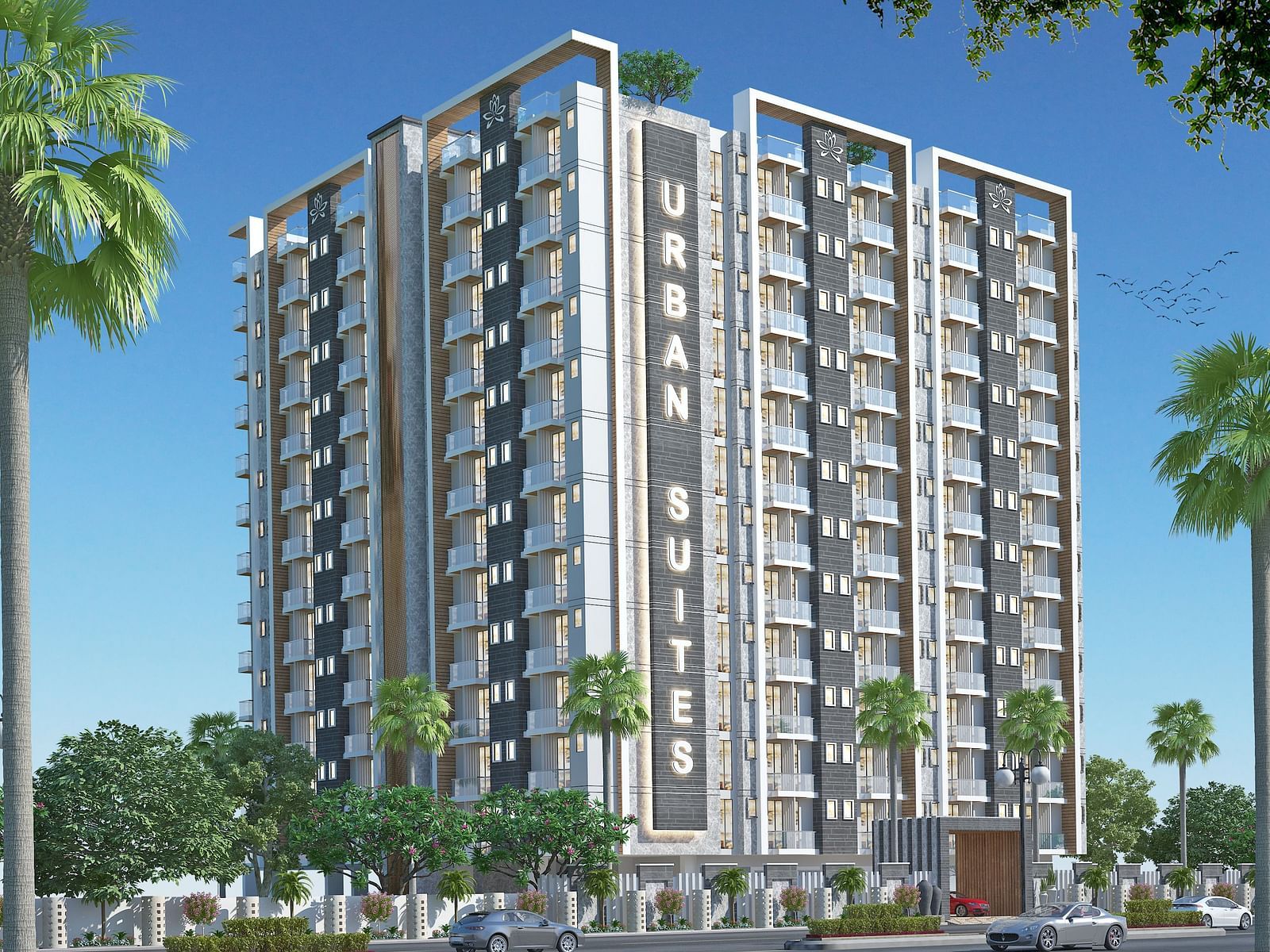 Facade view of Urban Suites by BluSalzz, Jaipur against the sky, with tree leaves framing the foreground.