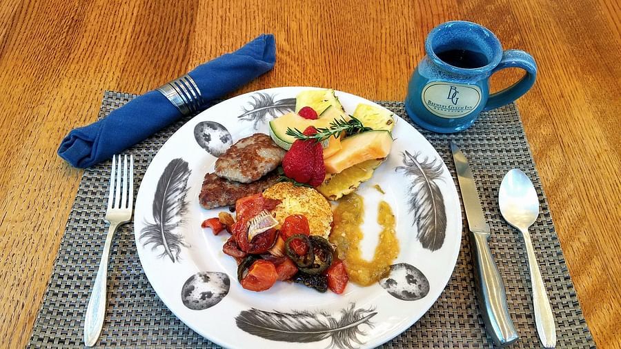 A close-up of a meal featuring fresh vegetables and proteins - Brewery Gulch Inn & Spa